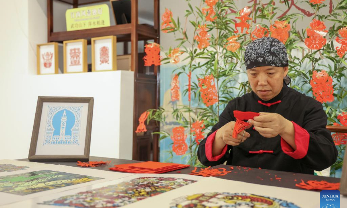 An artist displays Anyuan paper-cutting at Tea for Harmony: Yaji Cultural Salon, in Rabat, Morocco, May 9, 2025. A culture and tourism promotion event of east China's Jiangxi Province was held here Friday to showcase the elegance and flavor of the Chinese tea and the cultural charm of Jiangxi to the Moroccan public. (Xinhua/Huo Jing)