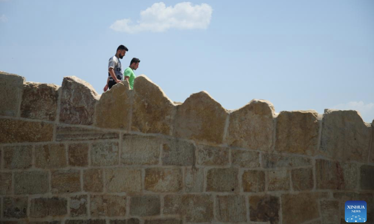 People walk on the ancient Dalal Bridge in Dohuk province, Iraq, May 10, 2025. The construction of Dalal Bridge dates back to the period of the Byzantine Empire. (Xinhua/Duan Minfu)