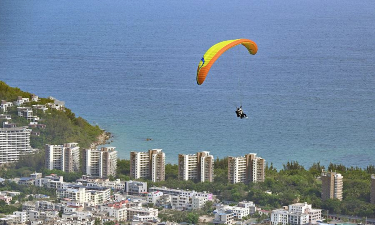 A tourist enjoys paragliding in Lingshui Li Autonomous County, south China's Hainan Province, May 3, 2025.  (Xinhua/Guo Cheng)