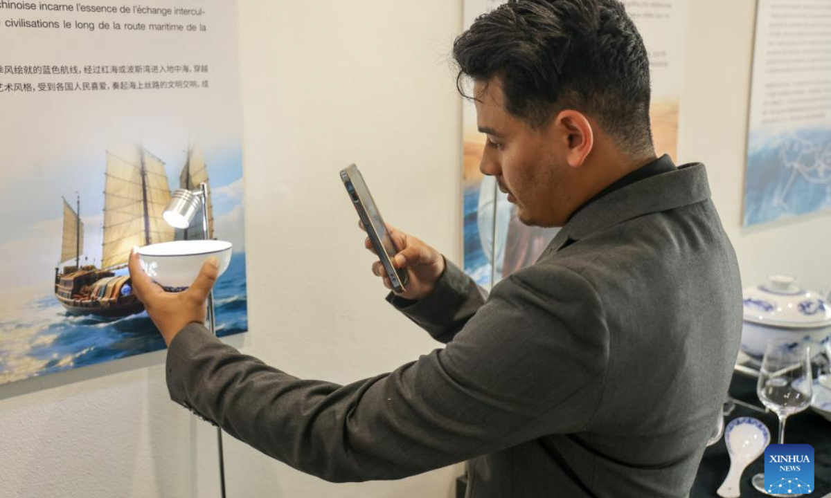 A Moroccan visitor takes photo of a porcelain bowl from Jingdezhen of China's Jiangxi Province at Tea for Harmony: Yaji Cultural Salon, in Rabat, Morocco, May 9, 2025. A culture and tourism promotion event of east China's Jiangxi Province was held here Friday to showcase the elegance and flavor of the Chinese tea and the cultural charm of Jiangxi to the Moroccan public. (Xinhua/Huo Jing)