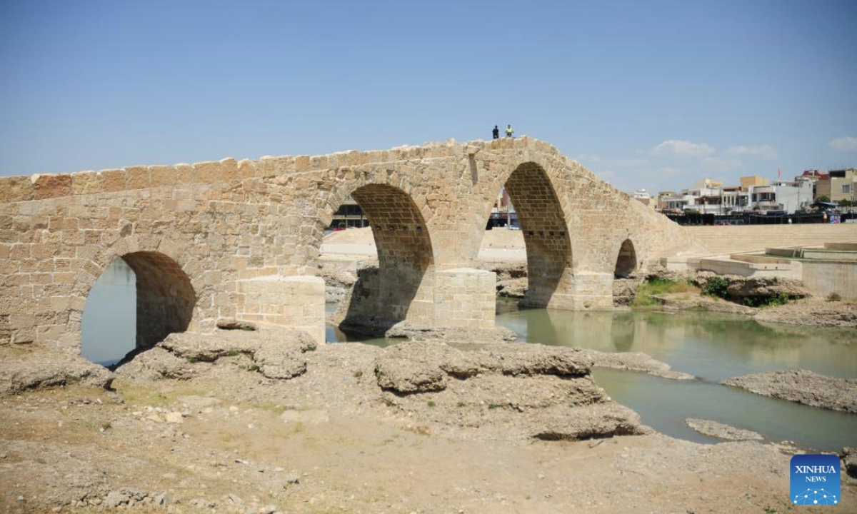 People walk on the ancient Dalal Bridge in Dohuk province, Iraq, May 10, 2025. The construction of Dalal Bridge dates back to the period of the Byzantine Empire. (Xinhua/Duan Minfu)