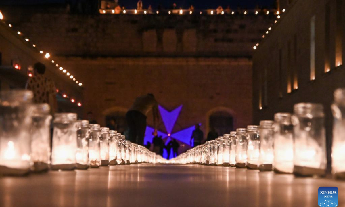 People visit a museum illuminated with light of candles in Birgu, Malta, on May 10, 2025. Heritage Malta, in collaboration with the Birgu Local Council, on Saturday hosted the Museums by Candlelight event. (Photo by Jonathan Borg/Xinhua)