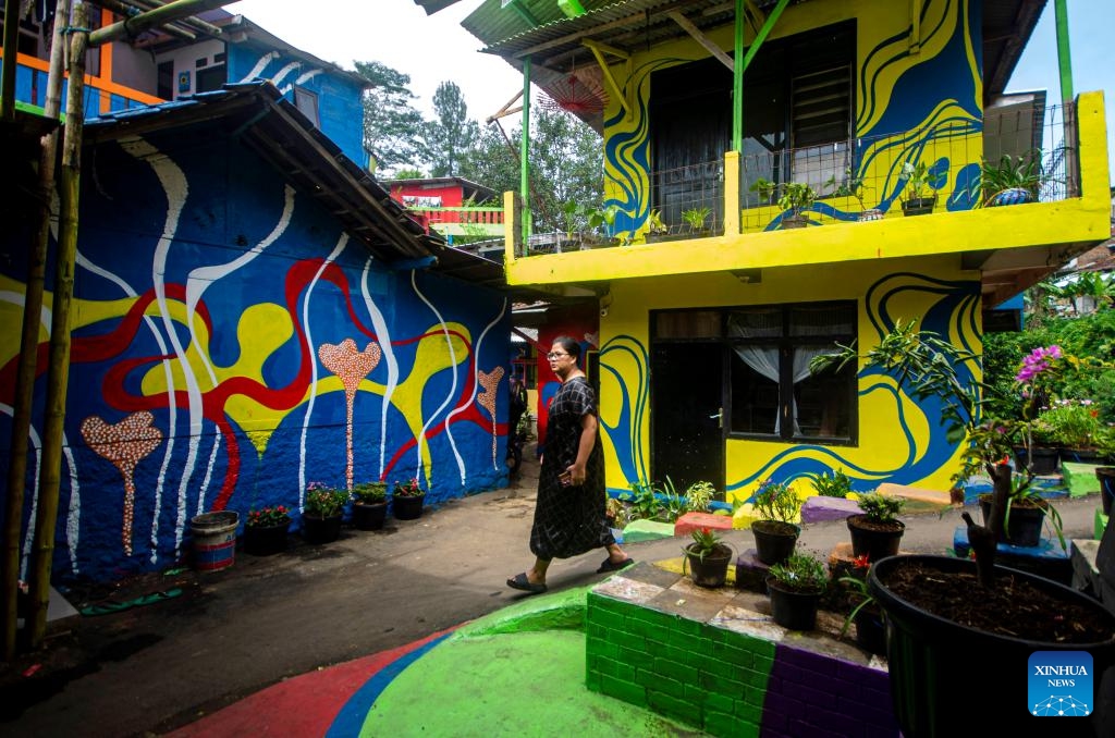A woman walks at Katumbiri village known for its colourful houses in Bandung, West Java, Indonesia, May 7, 2025. (Photo: Xinhua)