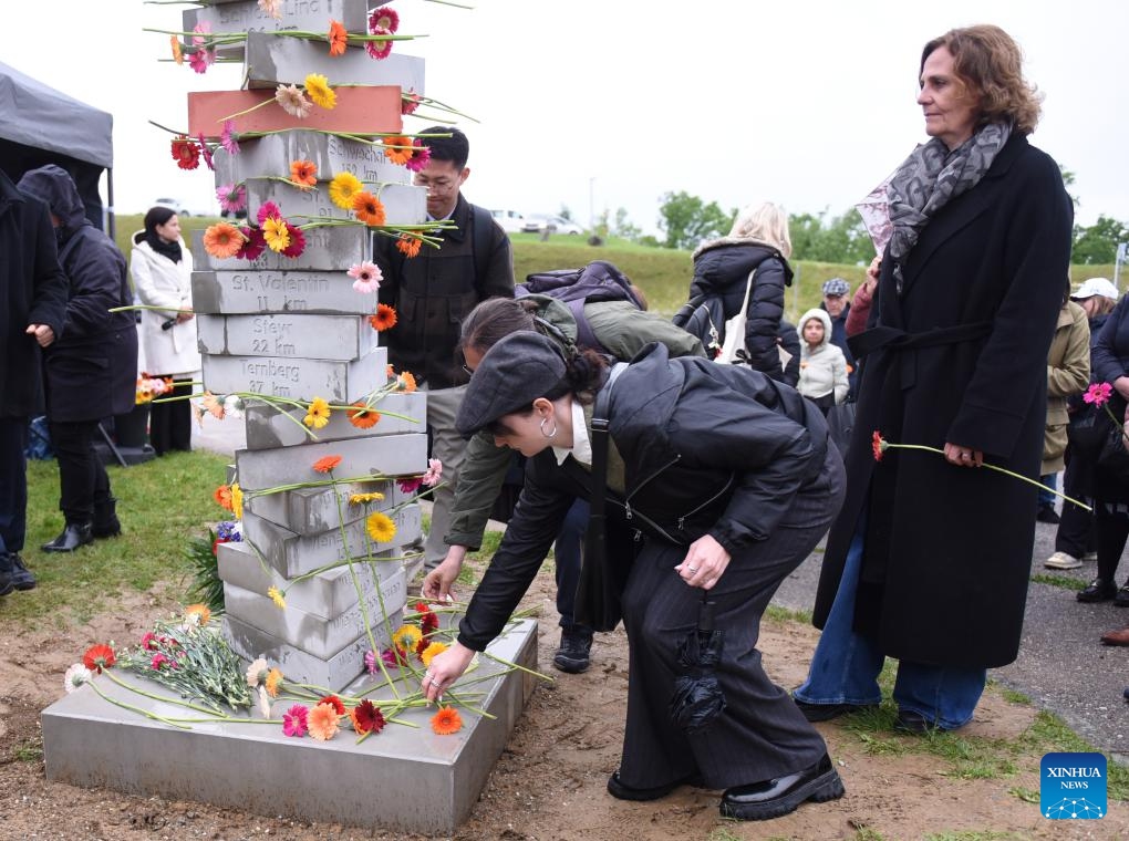 People lay flowers on a new monument of Mauthausen Concentration Camp Memorial in Upper Austria, Austria, May 5, 2025. The Mauthausen Concentration Camp was the first concentration camp established in a foreign country by Nazi Germany. It was built in August 1938 and liberated by the Allied forces in May 1945. The camp was converted into a museum after World War II. Ceremony was held every year to pay tribute to victims killed by the Nazi Germany. (Photo: Xinhua)