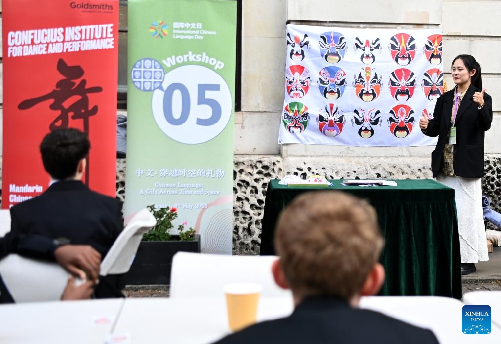 Students learn opera facial mask painting during an event marking Chinese Language Day in London, Britain, on May 8, 2025. An event marking this year's Chinese Language Day was held on Thursday in London, bringing together around 100 students from six schools across Britain to celebrate the Chinese language and culture. (Photo: Xinhua)