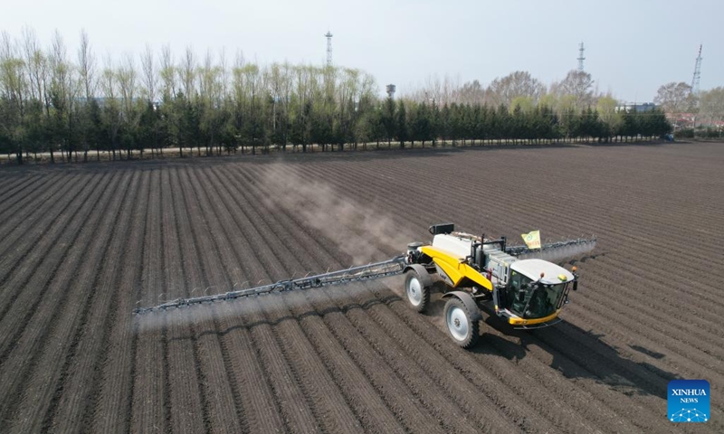 A drone photo taken on May 8, 2025 shows an agricultural machine conducting soil treatment in a field of a farming company under Beidahuang Group in northeast China's Heilongjiang Province. At present, the spring sowing in Heilongjiang cultivation areas are in full swing. All agricultural production units of Beidahuang Group, one of China's leading agricultural conglomerates, are seizing the farming season and busy with the sowing operations in both paddy rice fields and dry fields. (Photo: Xinhua)