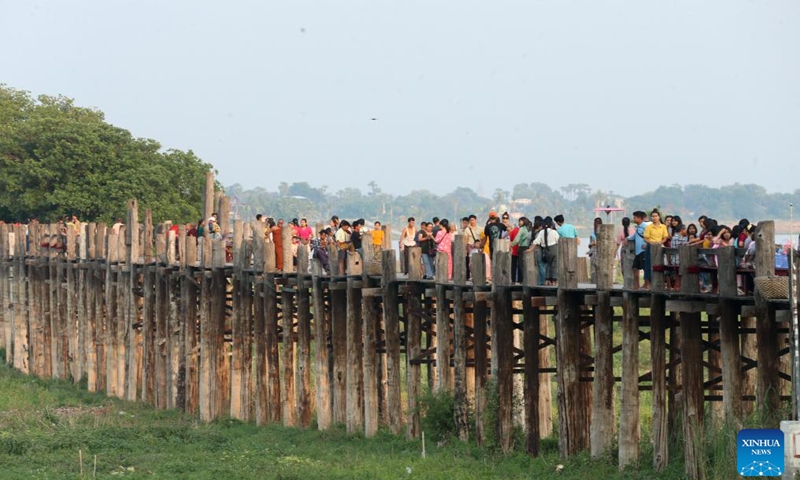 People walk on the U Bein Bridge in Mandalay, Myanmar, May 11, 2025. (Xinhua/Myo Kyaw Soe)