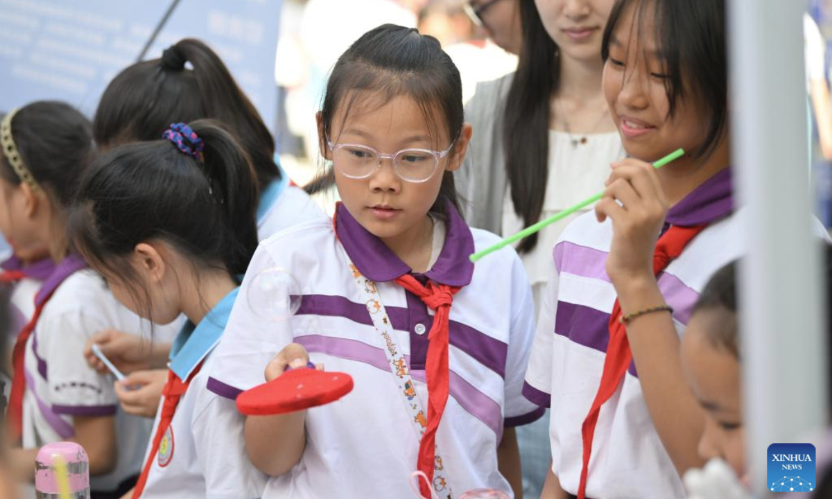 Primary school students play with bubbles at Tianjin Normal University in north China's Tianjin, May 15, 2025. A cultural festival featuring science and innovation kicked off on Thursday at Tianjin Normal University. Students from nine primary schools in Tianjin participated in a science market and watched science plays at the event. (Xinhua/Li Ran)
