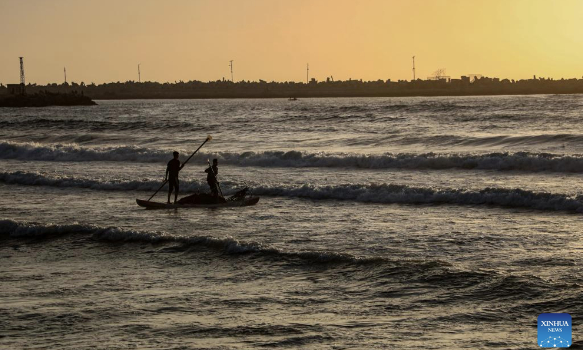 Palestinians enjoy their time on the beach during the sunset in Gaza City, on May 12, 2025. (Photo by Rizek Abdeljawad/Xinhua)