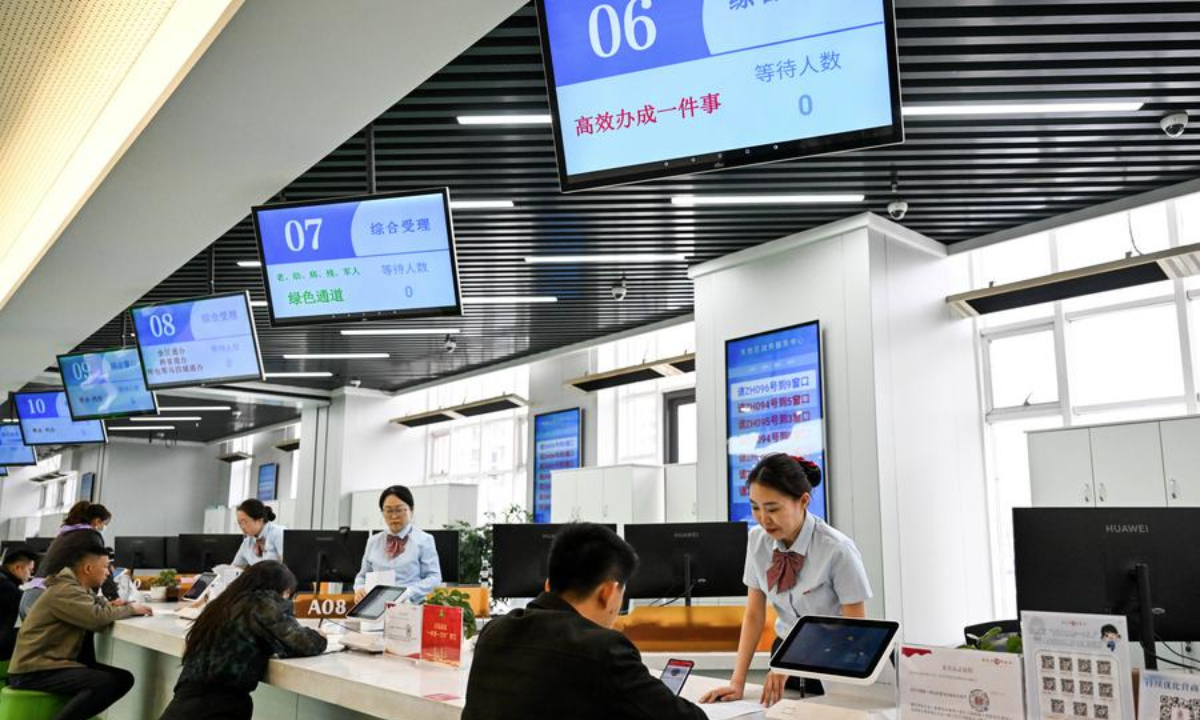 Staff members handle businesses related to private enterprises at the government service center of Dongsheng District in Ordos City, north China's Inner Mongolia Autonomous Region, April 16, 2025. (Xinhua/Li Zhipeng)