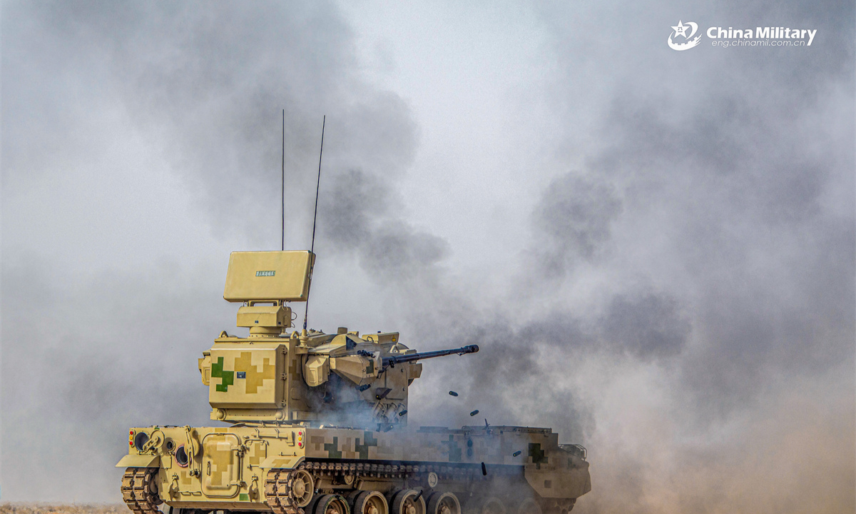 A PGZ-09 dual 35mm wheeled self-propelled anti-aircraft gun system (SPAAG) attached to an air-defense unit with a combined-arms regiment under the Chinese PLA Xinjiang Military Command fires at targets during a live-fire air defense training exercise in early May, 2025. (eng.chinamil.com.cn/Photo by Feng Kesheng)