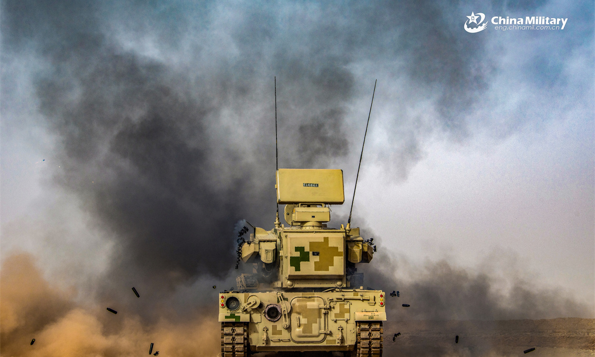 A PGZ-09 dual 35mm wheeled self-propelled anti-aircraft gun system (SPAAG) attached to an air-defense unit with a combined-arms regiment under the Chinese PLA Xinjiang Military Command fires at targets during a live-fire air defense training exercise in early May, 2025. (eng.chinamil.com.cn/Photo by Feng Kesheng)
