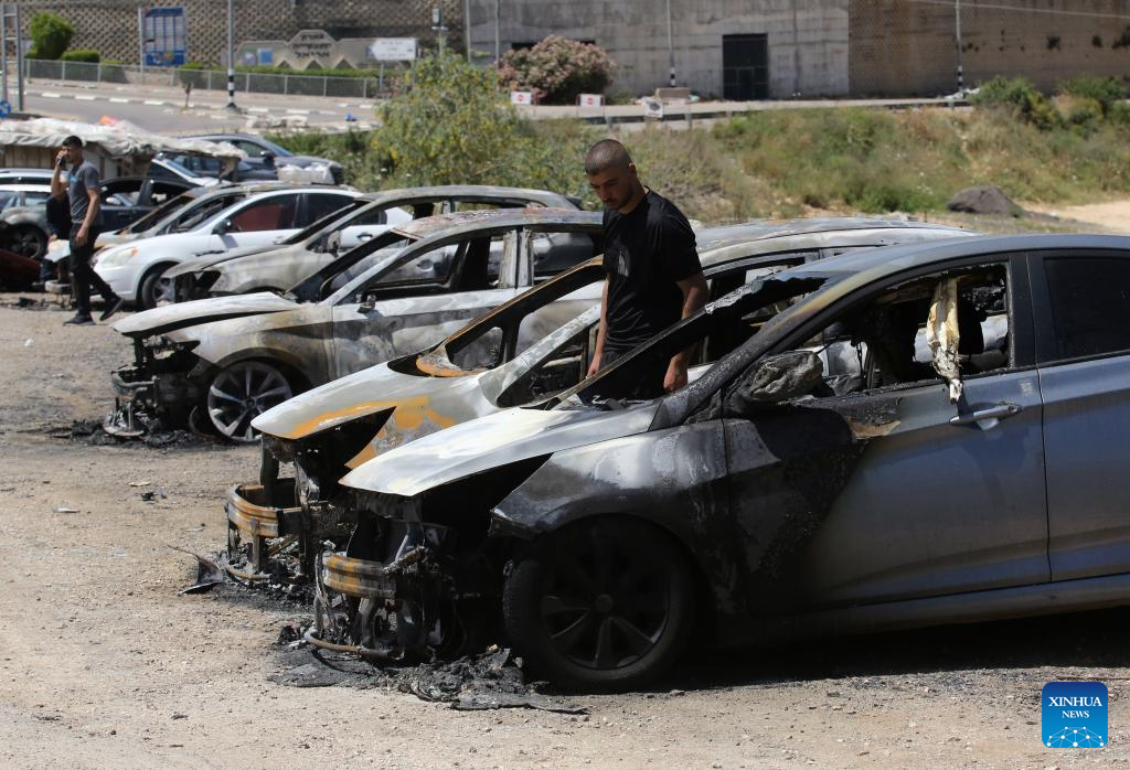 A Palestinian checks cars burned by Israeli settlers near the West Bank city of Salfit, May 16, 2025. (Photo by Nidal Eshtayeh/Xinhua)