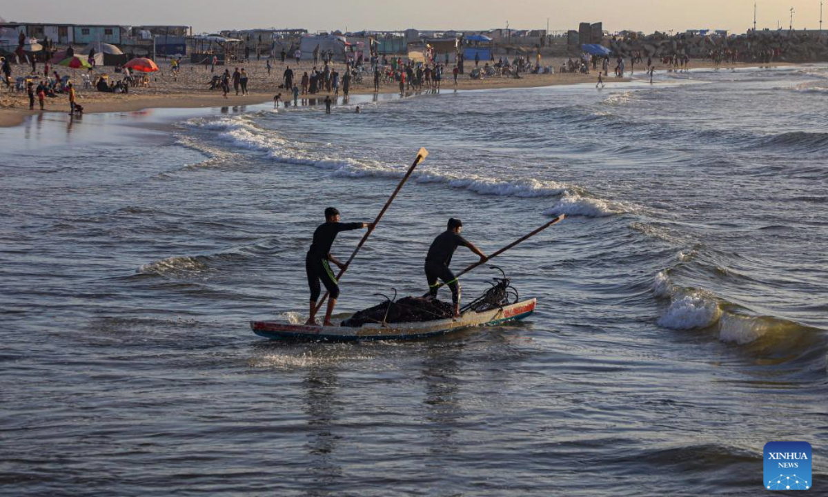 Palestinians enjoy their time on the beach during the sunset in Gaza City, on May 12, 2025. (Photo by Rizek Abdeljawad/Xinhua)