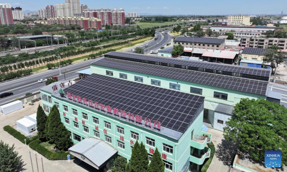 An aerial drone photo taken on May 14, 2025 shows rooftop photovoltaic devices at a modern agriculture company in Yuanshi County, north China's Hebei Province. In recent years, Yuanshi County has encouraged local companies to set up photovoltaic power generation devices on their roofs, aiming to promote the development of green economy and to reduce their management cost. These rooftop devices now boast a combined power generating capacity of 29.49 megawatt connected to the power grid. (Xinhua/Mu Yu)