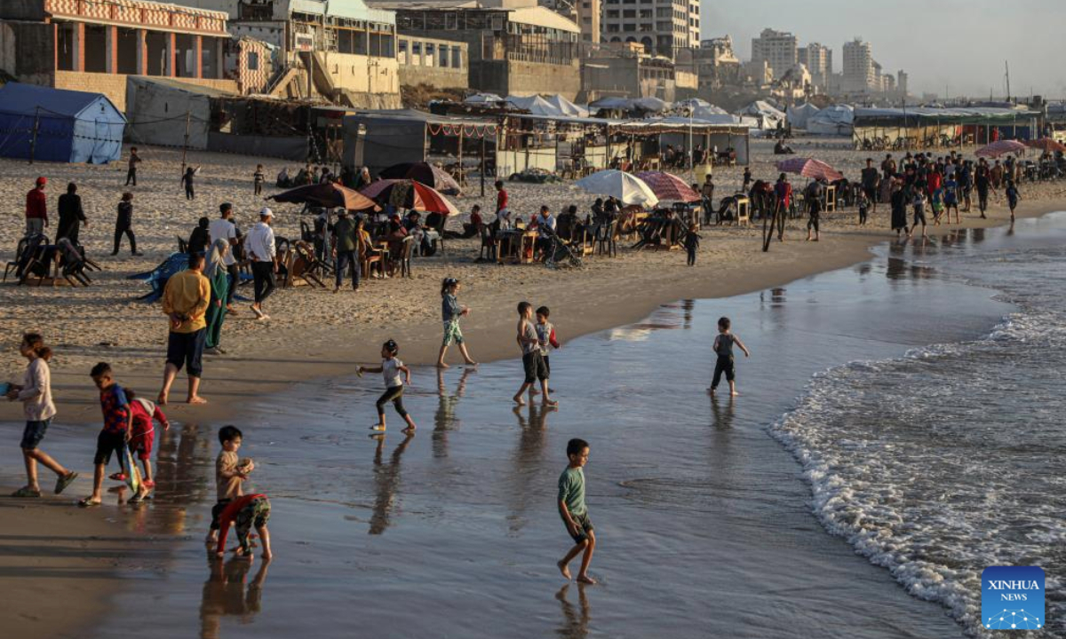 Palestinians enjoy their time on the beach during the sunset in Gaza City, on May 12, 2025. (Photo by Rizek Abdeljawad/Xinhua)