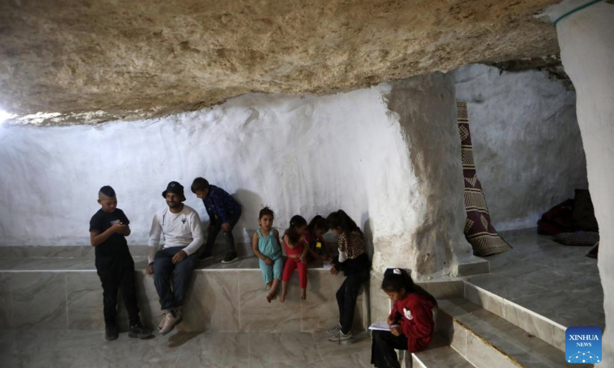 Palestinians are pictured inside a cave after the Israeli forces demolished their structures in the village of Khallet al-Dabaa in Masafer Yatta, southern West Bank city of Hebron, on May 12, 2025. (Photo by Mamoun Wazwaz/Xinhua)