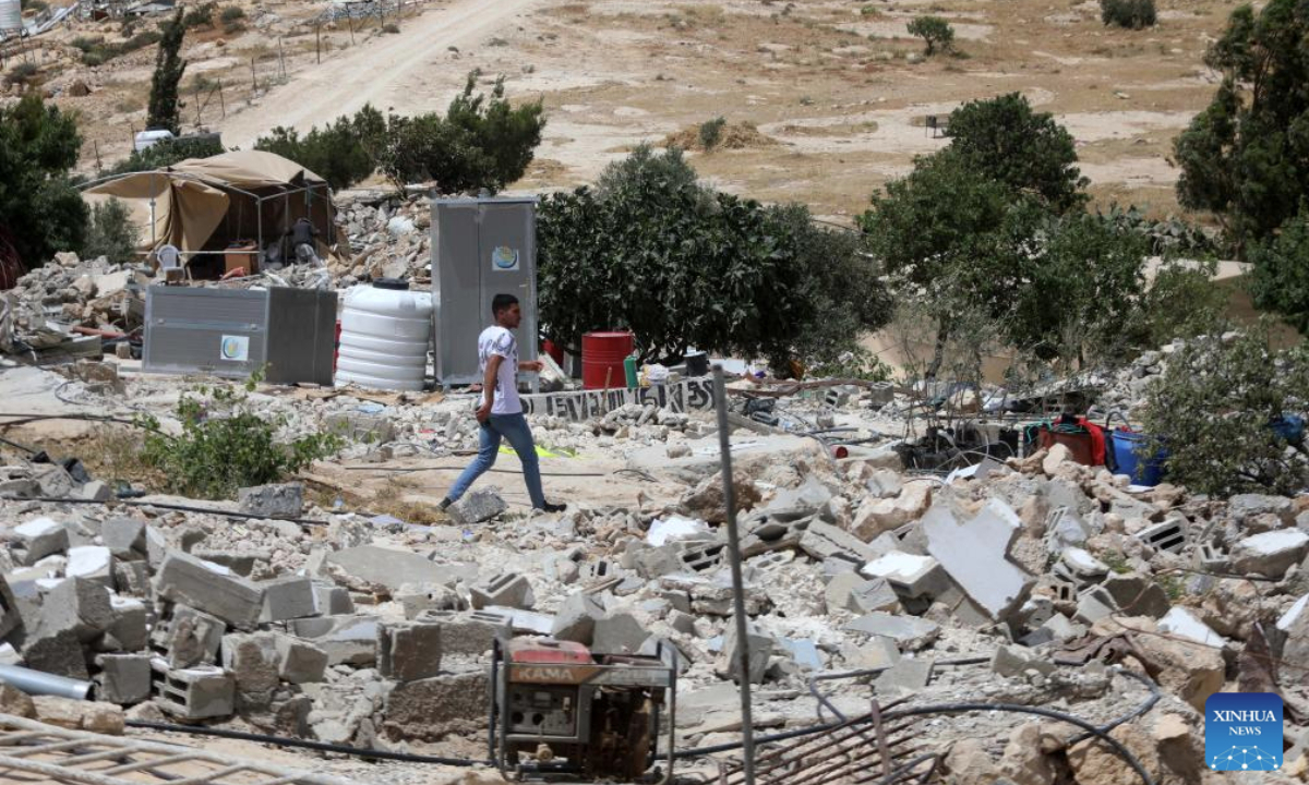 A man walks among rubble after the Israeli forces demolished the structures in the village of Khallet al-Dabaa in Masafer Yatta, southern West Bank city of Hebron, on May 12, 2025. (Photo by Mamoun Wazwaz/Xinhua)