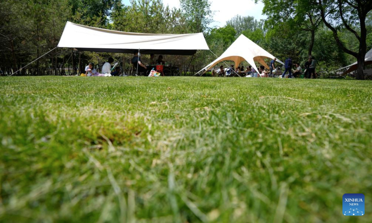 People enjoy camping at Haibao park in Yinchuan, northwest China's Ningxia Hui Autonomous Region, May 25, 2025. (Xinhua/Wang Peng)