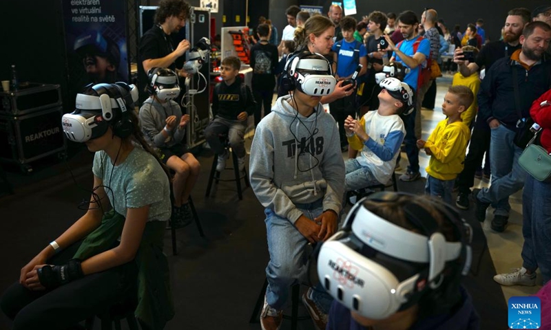 Children take part in a virtual tour of the power plant during the Maker Faire Prague 2025 in Prague, the Czech Republic, May 11, 2025.