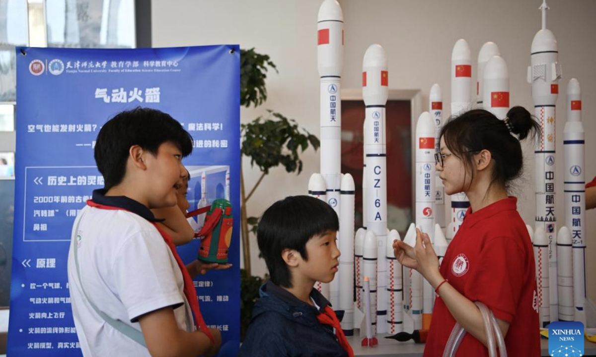 Primary school students learn about rockets at Tianjin Normal University in north China's Tianjin, May 15, 2025. A cultural festival featuring science and innovation kicked off on Thursday at Tianjin Normal University. Students from nine primary schools in Tianjin participated in a science market and watched science plays at the event. (Xinhua/Li Ran)