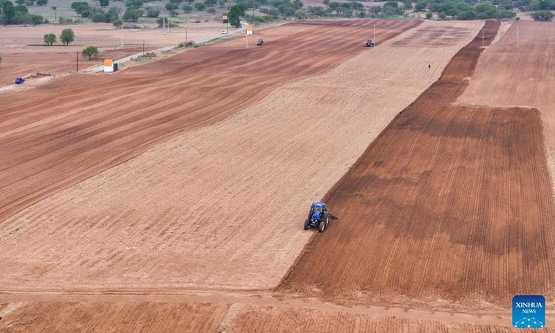 An aerial drone photo taken on May 9, 2025 shows farmers operating tractors equipped with Beidou navigation system for plowing in Horqin Left Wing Rear Banner of Tongliao City, north China's Inner Mongolia Autonomous Region. (Xinhua/Lian Zhen)