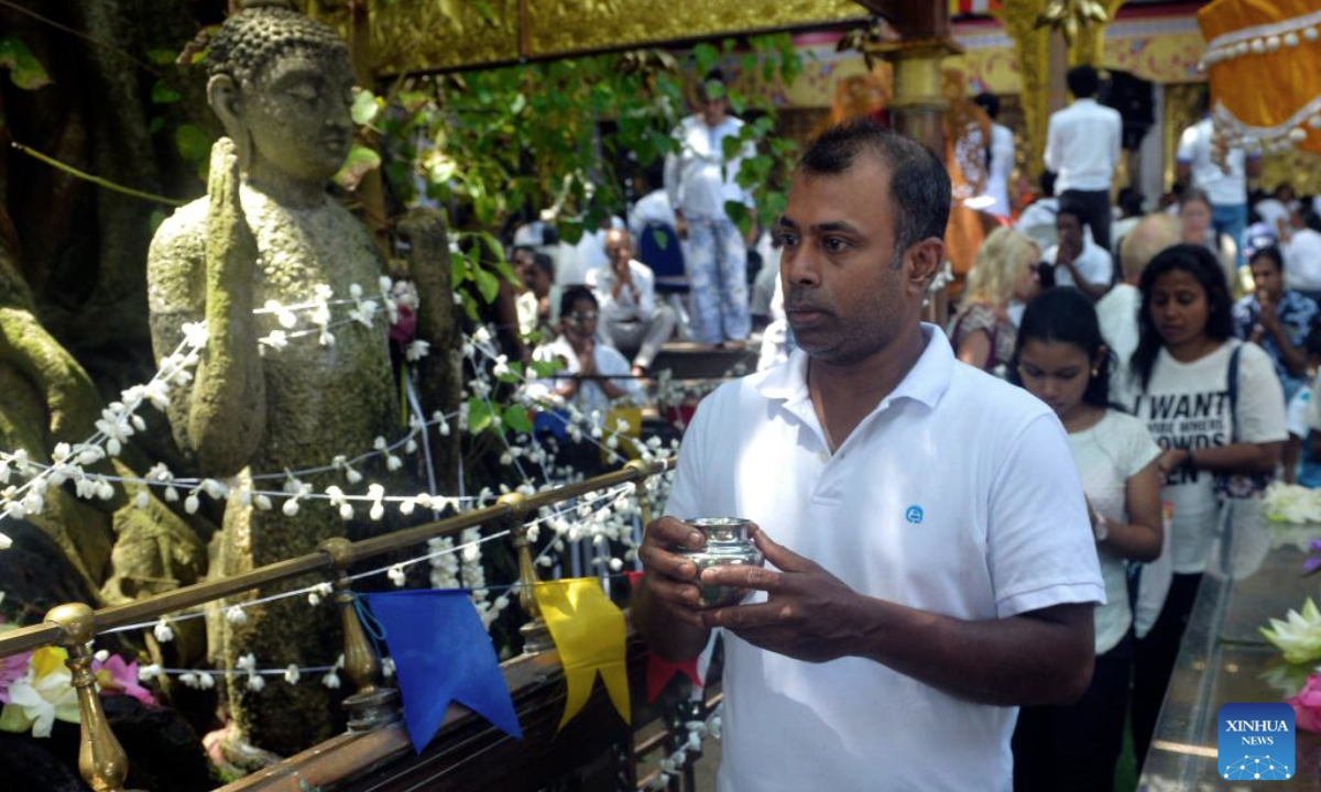 People participate in a celebration of Vesak Day in Colombo, Sri Lanka, on May 12, 2025. (Photo by Gayan Sameera/Xinhua)