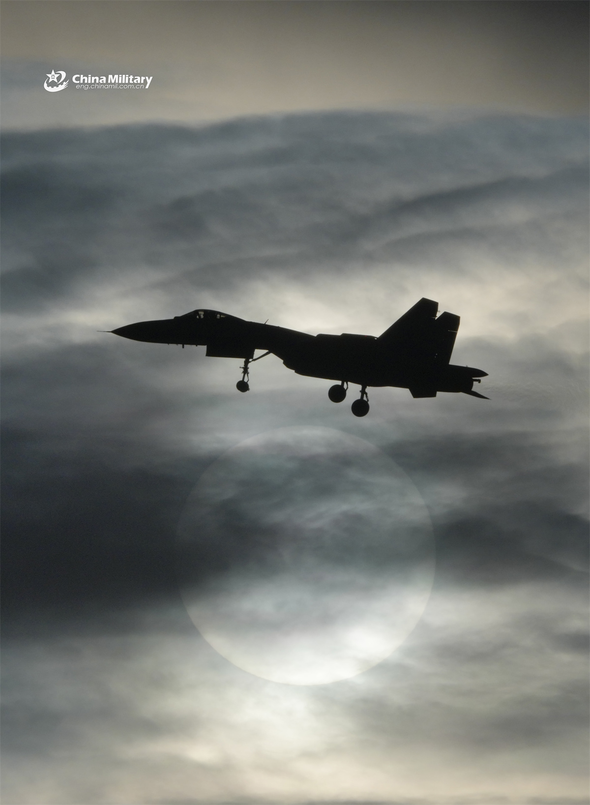 A fighter jet attached to a base under the Chinese PLA Naval Aviation University dances on the sun's rim during a recent flight training exercise. (eng.chinamil.com.cn/Photo by Yu Tao)