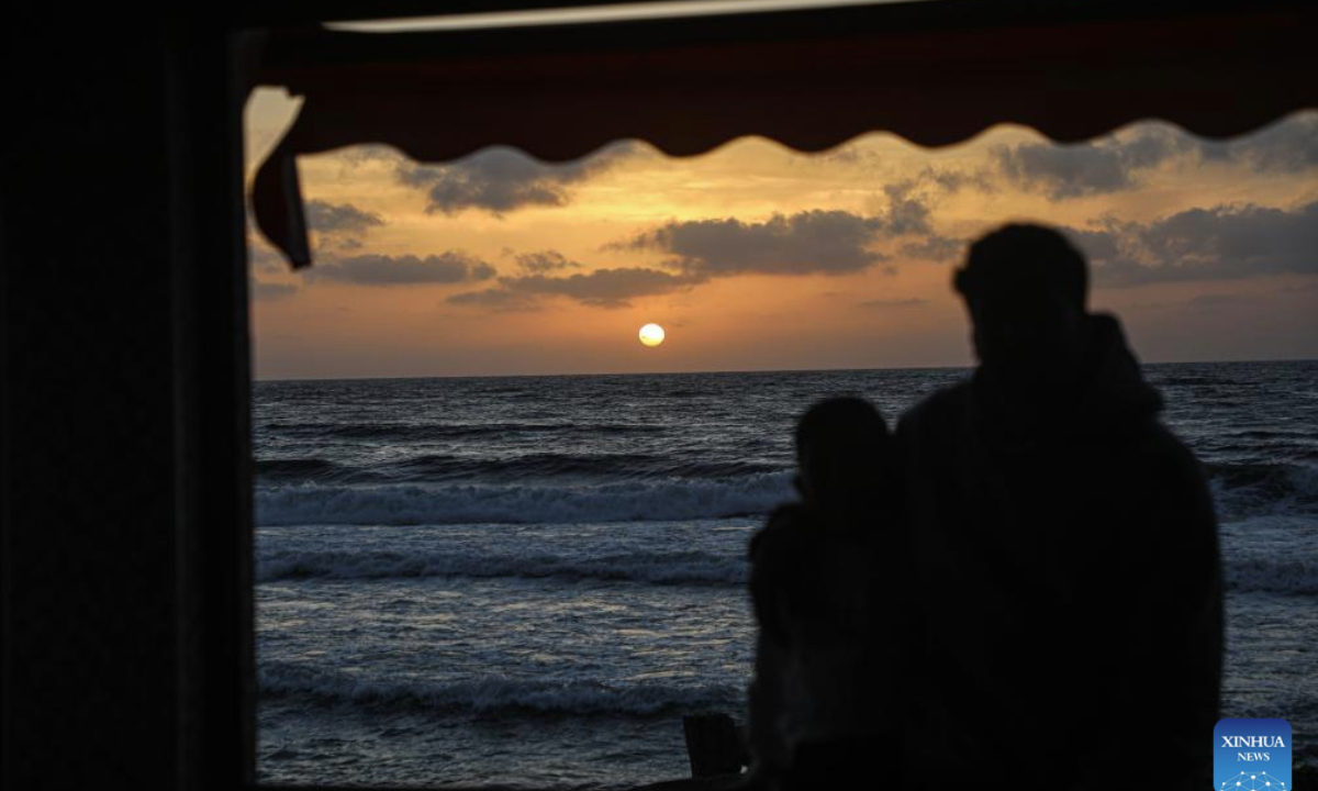 Palestinians enjoy their time on the beach during the sunset in Gaza City, on May 12, 2025. (Photo by Rizek Abdeljawad/Xinhua)