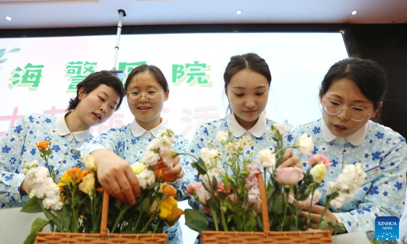 Nurses participate in a flower arrangement activity at a hospital in Jiaxing, east China's Zhejiang Province, May 9, 2025. International Nurses Day, which falls annually on May 12, have recently been observed across China in various forms. (Photo by Jin Peng/Xinhua)