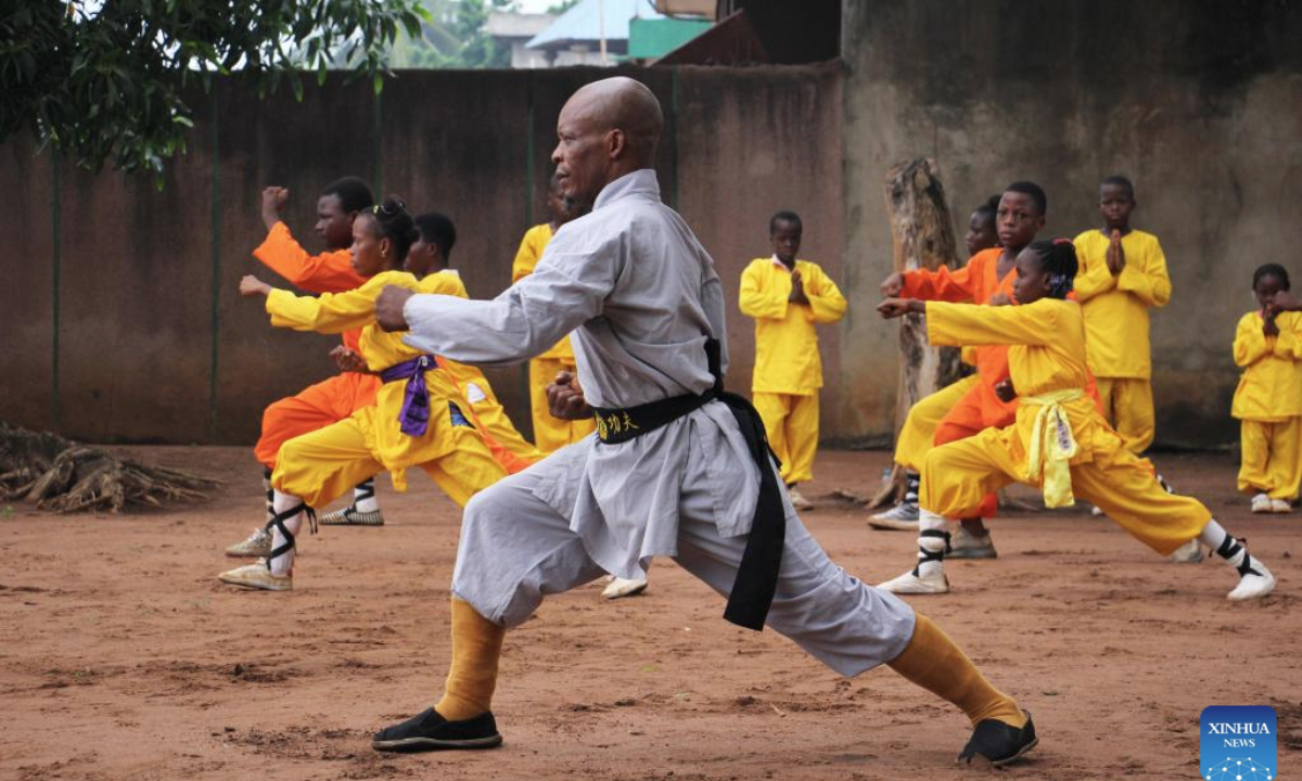 Damien Agossou Degbo (front) instructs his students at his martial arts club in Akpro-Misserete, a town some 40 kilometers northeast of Benin's economic capital Cotonou, on May 18, 2025.(Photo by Seraphin Zounyekpe/Xinhua)