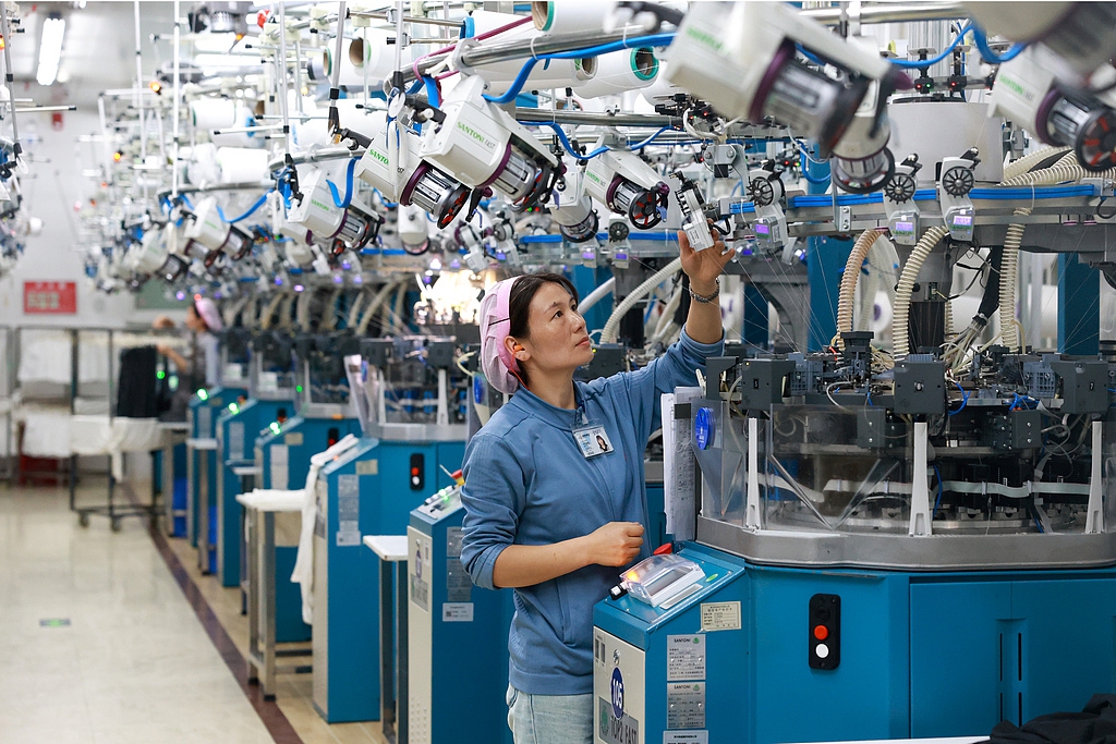 Workers at a garment company rush to fill orders on a production line in the economic development zone of Sansui county, Southwest China's Guizhou Province, on May 14, 2025, to meet demand from both domestic and overseas markets. Photo: VCG