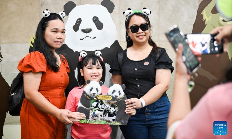 People pose for photos at the Zoo Negara near Kuala Lumpur, Malaysia, May 17, 2025. As the giant panda pair Xing Xing and Liang Liang, formerly known as Fu Wa and Feng Yi in China, are scheduled to return to China on May 18, 2025, people on Saturday bid farewell to them at the Zoo Negara. The pair arrived in Malaysia on May 21, 2014. (Photo: Xinhua)