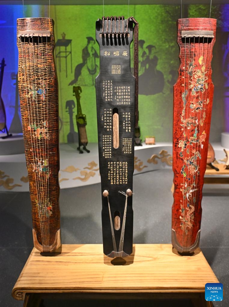 This photo taken on May 11, 2025 shows Chinese Guqins displayed at the Chengdu Xin Smart Music Museum in Chengdu, southwest China's Sichuan Province. Chengdu Xin Smart Music Museum, home to a collection of over 300 instruments from all over the world, is designed to enable an immersive experience for visitors. With technologies such as 3D imaging, holographic theatres, and digital scene restoration, it reflects virtual historical scenarios, tells stories behind music works, and sheds light on technology innovations in those instruments. The museum has received about 50,000 visitors in since it opened on April 30, 2024. (Photo: Xinhua)