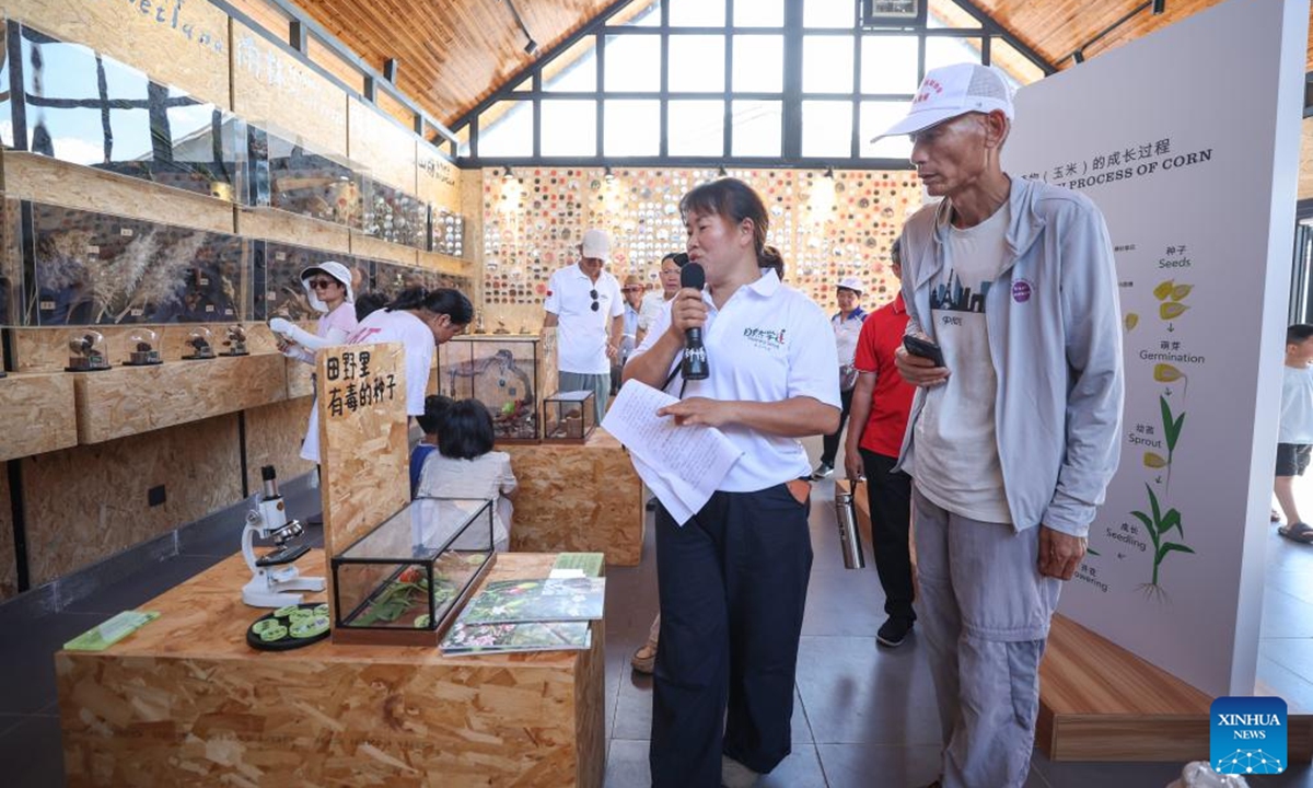 People visit the Jiusuo seed museum in Jiusuo Village, Fuwen Township of Ding'an County, south China's Hainan Province, May 17, 2025. Located in Jiusuo Village, Jiusuo seed museum, home to a collection of more than 800 kinds of seeds and specimens, serves as a vivid learning platform for the public through displays, graphic explanation and interactive experiences.  (Xinhua/Zhang Liyun)