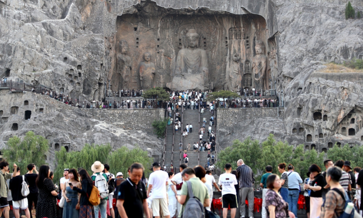 Tourists visit the Longmen Grottoes scenic area in Luoyang, Central China's Henan Province, on May 20, 2025. The Longmen Grottoes, a UNESCO World Heritage site, has more than 2,300 grottoes with 110,000 Buddhist figures and images, more than 80 dagobas and 2,800 inscribed tablets, most of which were created between the Northern Wei (386-534) and Song (960-1279) dynasties. Photo: VCG