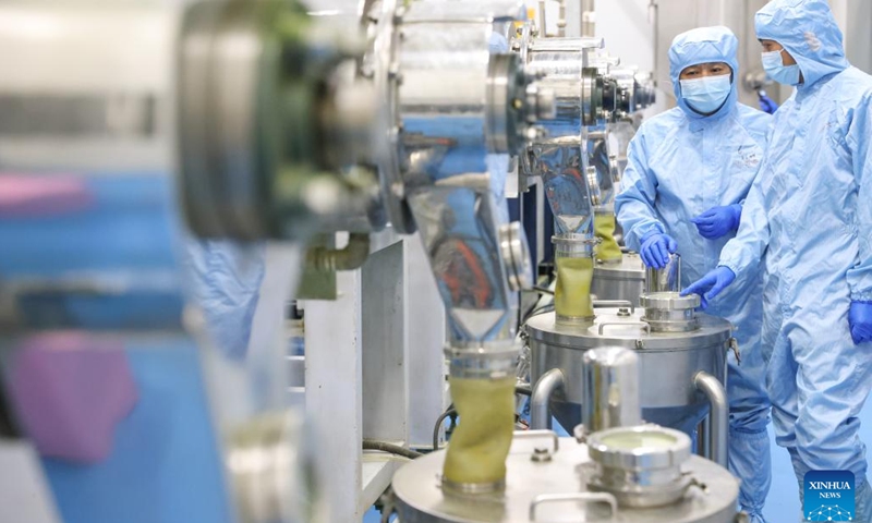Wei Yong (L) inspects a matcha production line with a colleague inside a workshop in Jiangkou County, southwest China's Guizhou Province, May 14, 2025.