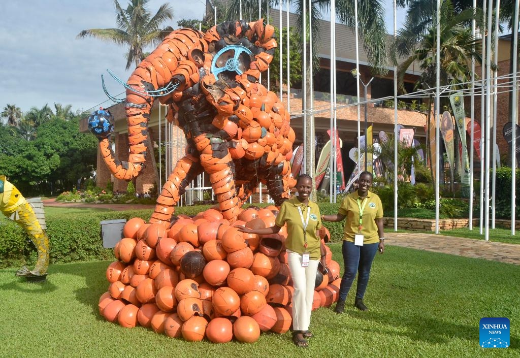 People pose for photos with an elephant statue made from plastic components during the three-day Pearl of Africa Tourism Expo in Kampala, Uganda, on May 21, 2025. The annual Pearl of Africa Tourism Expo, Uganda's premium tourism show, opened here on Wednesday as the East African country strives to boost tourist arrivals. (Photo by Nicholas Kajoba/Xinhua)