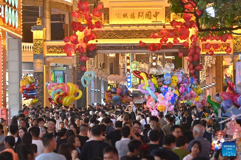 People walk on a street in Wuzhou, south China's Guangxi Zhuang Autonomous Region, May 1, 2025. In recent years, Guangxi has been continuously focusing on the upgrade of consumption experience and promoting the integration of cultural tourism and commerce. Various night fairs and booths have boosted consumption and injected vitality into the night economy. Photo: Xinhua