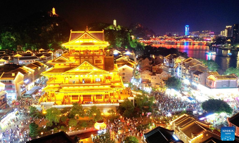 A drone photo shows people visiting Yaobu ancient town in Liuzhou, south China's Guangxi Zhuang Autonomous Region, May 3, 2025. In recent years, Guangxi has been continuously focusing on the upgrade of consumption experience and promoting the integration of cultural tourism and commerce. Various night fairs and booths have boosted consumption and injected vitality into the night economy. Photo: Xinhua