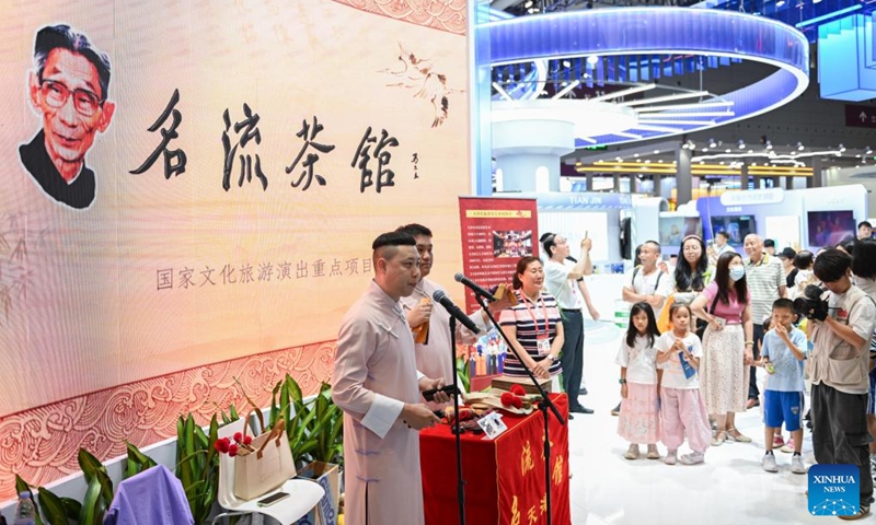 Visitors watch a clapper talk show at the exhibition area of Tianjin during the 21st China (Shenzhen) International Cultural Industries Fair in Shenzhen, south China's Guangdong Province, May 24, 2025. Opened here on Thursday, the five-day event is being held across eight exhibition halls -- three comprehensive spaces and five specialized areas. Activities related to traditional culture and cultural heritages attracted many young visitors. Photo: Xinhua