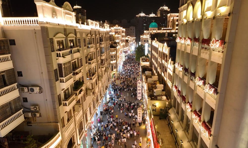 An aerial drone photo shows people walking on a street in Wuzhou, south China's Guangxi Zhuang Autonomous Region, May 1, 2025. In recent years, Guangxi has been continuously focusing on the upgrade of consumption experience and promoting the integration of cultural tourism and commerce. Various night fairs and booths have boosted consumption and injected vitality into the night economy. Photo: Xinhua