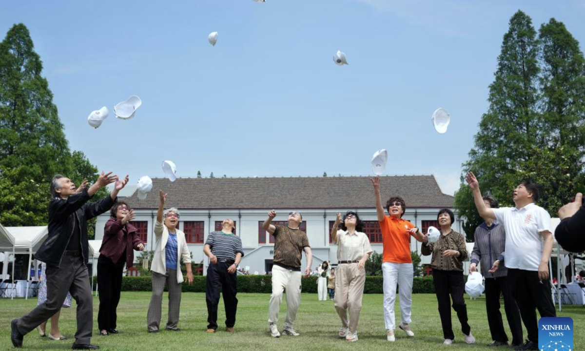 Alumni pose for photos on the campus of the Fudan University in Shanghai, east China, May 24, 2025. Founded in 1905, Fudan University is a comprehensive, research-oriented university based in Shanghai. (Xinhua/Liu Ying)
