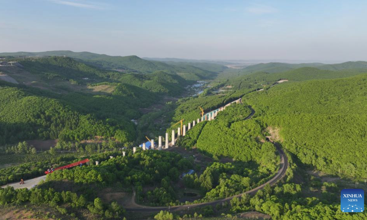 An aerial drone photo taken on May 27, 2025 shows an ongoing renovation project of a railway linking Suifenhe and China's border with Russia next to an existing rail line in Suifenhe, northeast China's Heilongjiang Province. Construction of this 602-meter railway tunnel started last May and was completed on Wednesday. The new tunnel will significantly boost line capacity of a railway linking Suifenhe and the China-Russia border, which is under renovation with a designed speed of 120 kilometers per hour. (Xinhua/Wang Song)