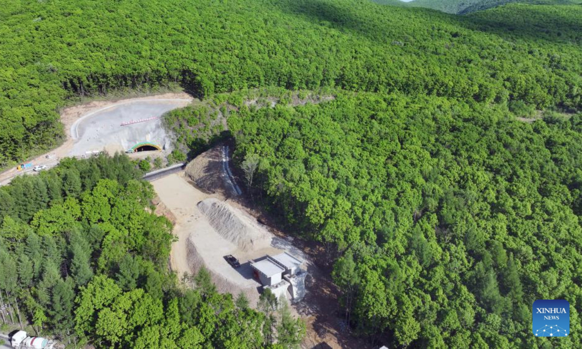 An aerial drone photo taken on May 27, 2025 shows the portal to a tunnel along a railway linking Suifenhe and China's border with Russia in Suifenhe, northeast China's Heilongjiang Province. Construction of this 602-meter railway tunnel started last May and was completed on Wednesday. The new tunnel will significantly boost line capacity of a railway linking Suifenhe and the China-Russia border, which is under renovation with a designed speed of 120 kilometers per hour. (Xinhua/Wang Song)