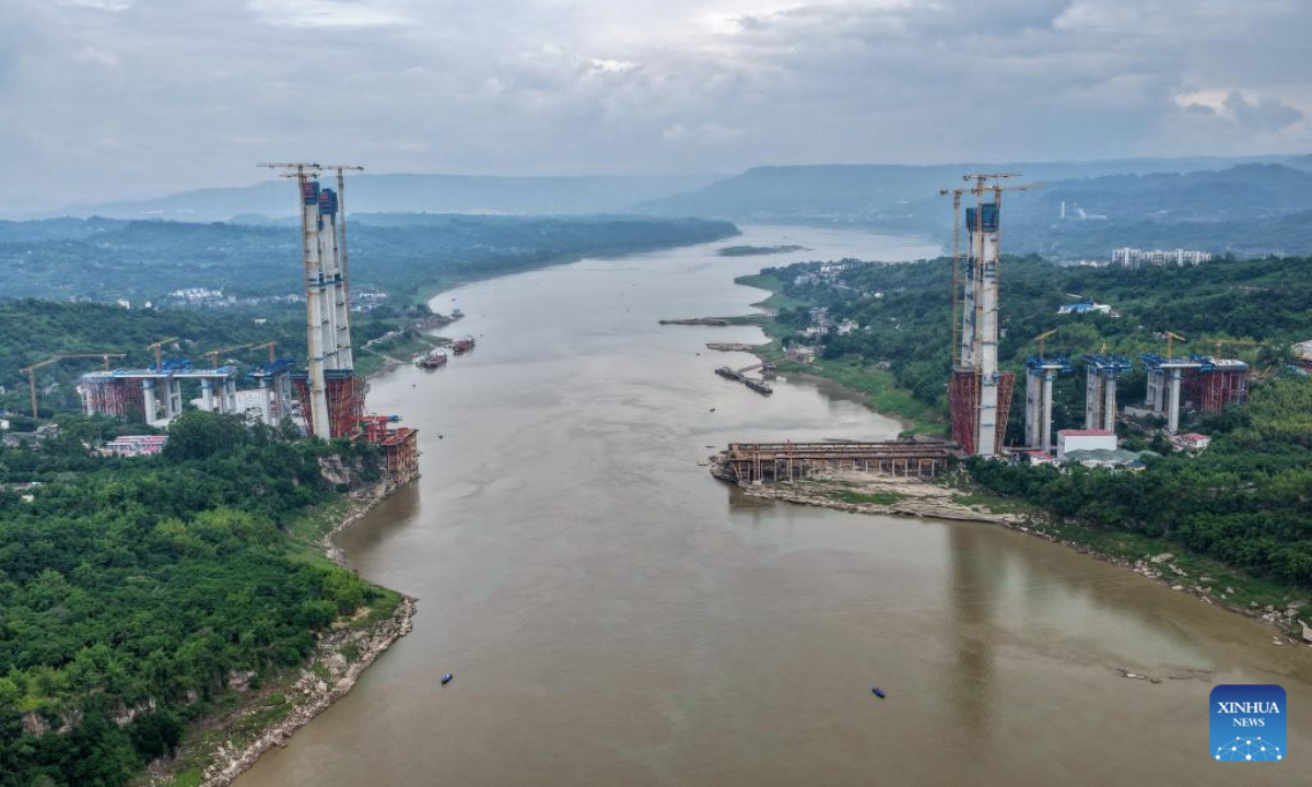 A drone photo taken on May 28, 2025 shows the construction site of Shituo Yangtze River Bridge along the Chongqing-Wanzhou high-speed railway in Chongqing, southwest China. With a height of 234.9 meters, the north main tower of the 1,056-meter bridge was successfully capped on Wednesday. (Xinhua/Tang Yi)