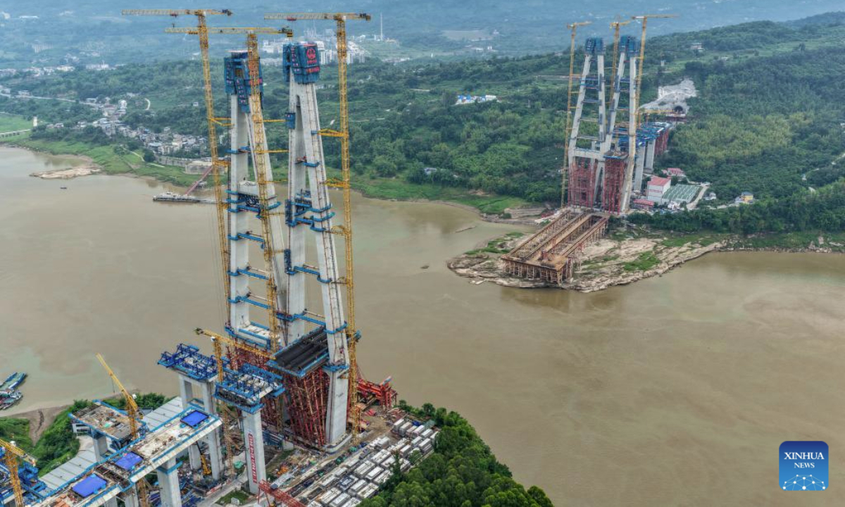 A drone photo taken on May 28, 2025 shows the construction site of Shituo Yangtze River Bridge along the Chongqing-Wanzhou high-speed railway in Chongqing, southwest China. With a height of 234.9 meters, the north main tower of the 1,056-meter bridge was successfully capped on Wednesday. (Xinhua/Tang Yi)