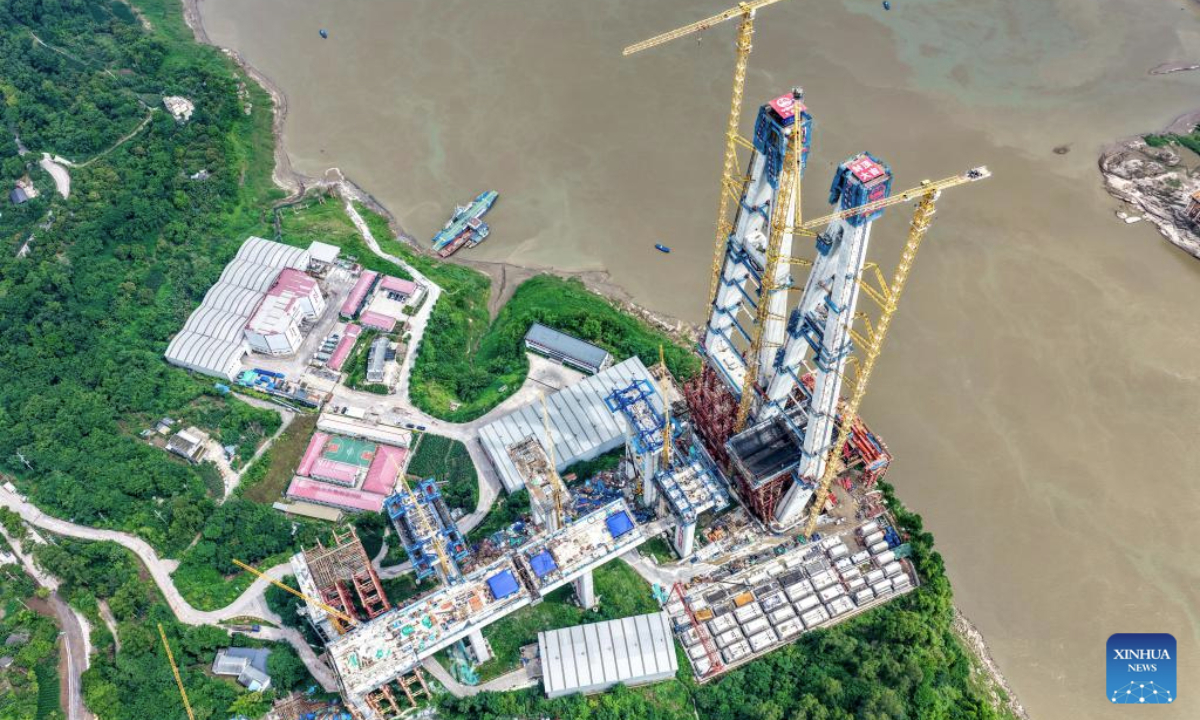 A drone photo taken on May 28, 2025 shows the construction site of Shituo Yangtze River Bridge along the Chongqing-Wanzhou high-speed railway in Chongqing, southwest China. With a height of 234.9 meters, the north main tower of the 1,056-meter bridge was successfully capped on Wednesday. (Xinhua/Tang Yi)