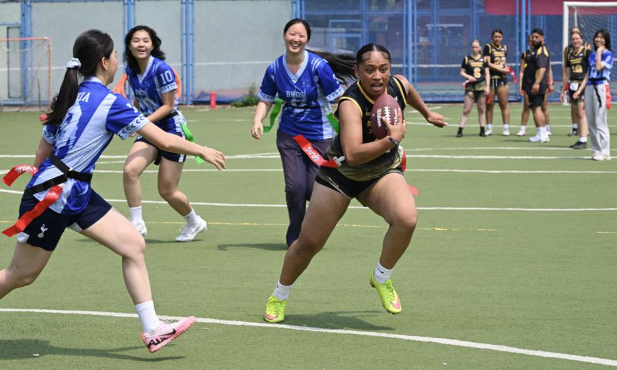 Students of Lincoln High School and Beijing National Day School compete during the NFL FLAG China-U.S. Youth Flag Football Exchange Event & Lincoln High School 2025 China Tour at Beijing National Day School in Beijing, capital of China, May 26, 2025. (Xinhua/Li He)