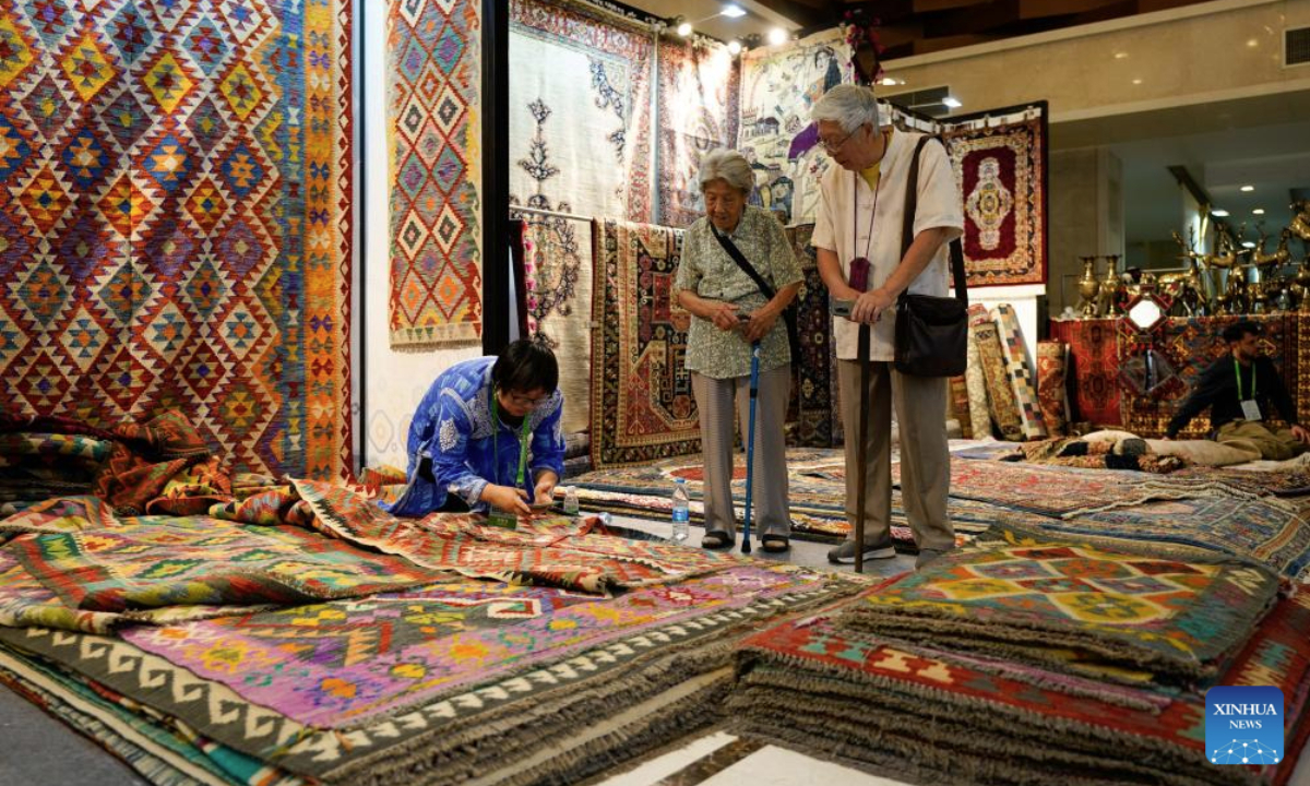Visitors learn about Afghan carpets during the 9th International Festival of the Intangible Cultural Heritage held in Chengdu, southwest China's Sichuan Province, May 28, 2025. The festival kicked off here on Wednesday, during which over 600 items of intangible cultural heritage from more than 60 countries and regions will be displayed. (Xinhua/Xu Bingjie)